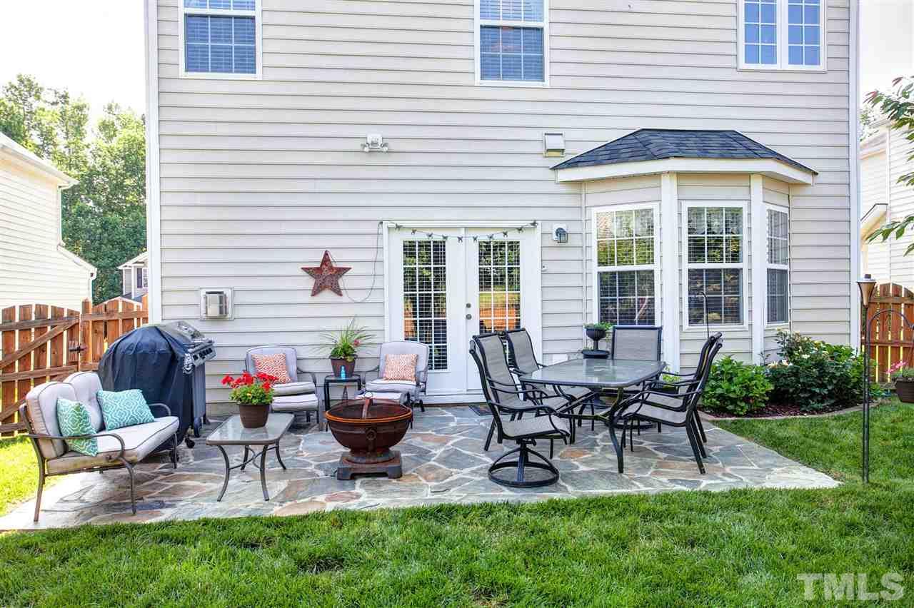 308 Inkster Cove Raleigh, NC 27603 - Photo 22 of 25 a view of a house with patio and a garden