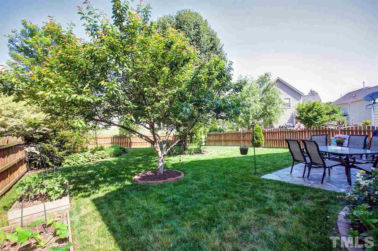 308 Inkster Cove Raleigh, NC 27603 - Photo 25 of 25 a view of a backyard with table and chairs and potted plants
