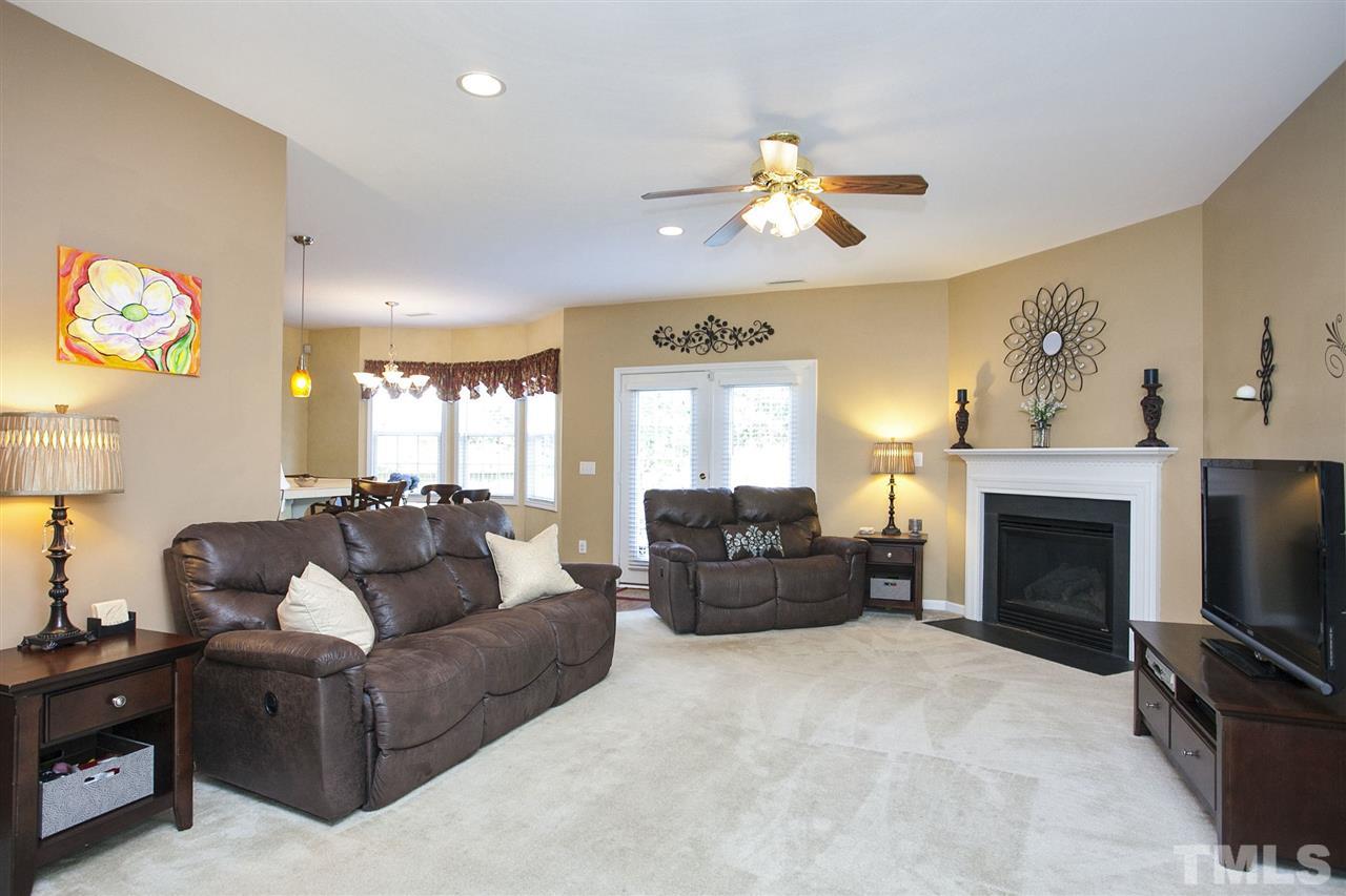 308 Inkster Cove Raleigh, NC 27603 - Photo 4 of 25 a living room with furniture a fireplace and a flat screen tv