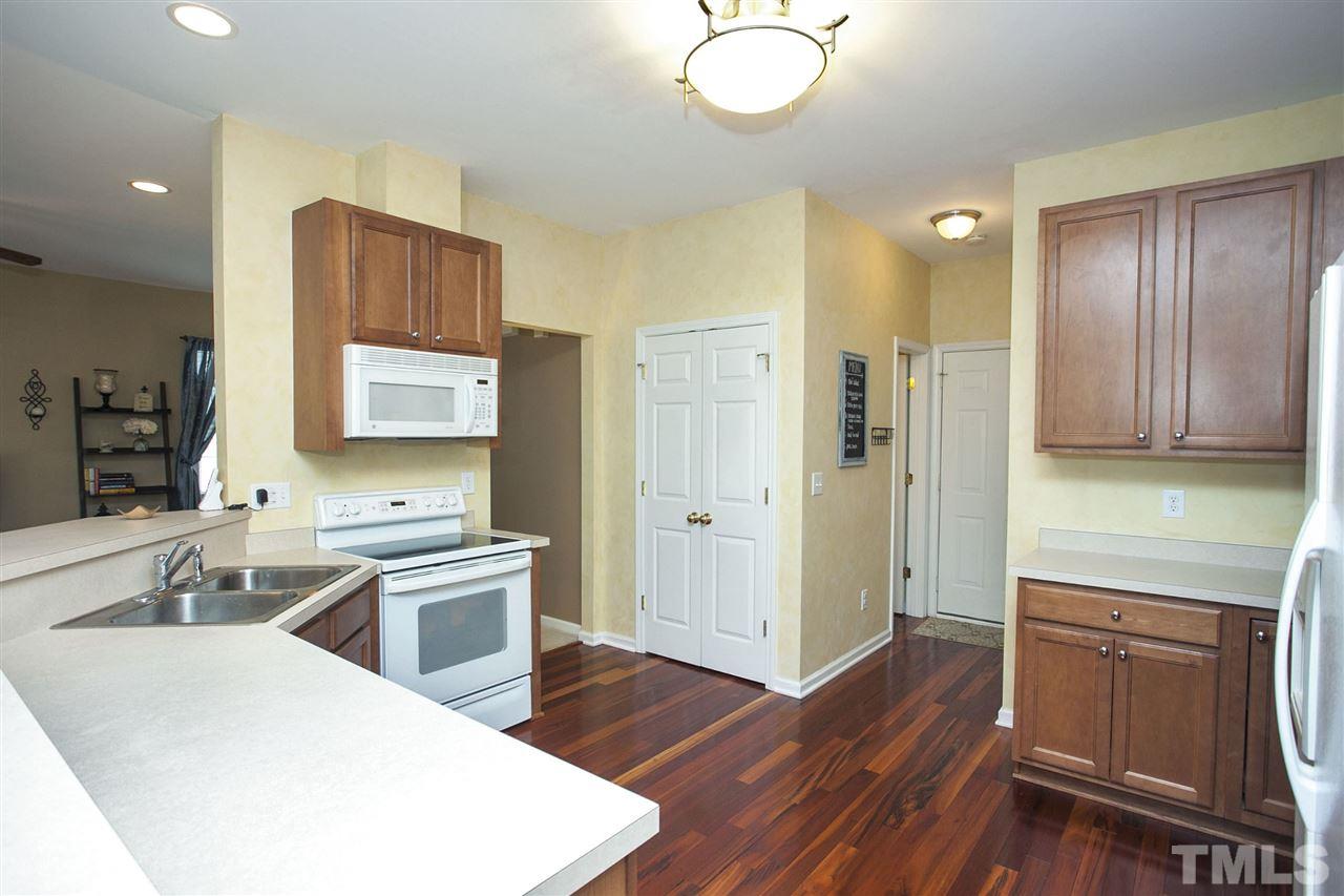308 Inkster Cove Raleigh, NC 27603 - Photo 8 of 25 a kitchen with a sink appliances and cabinets