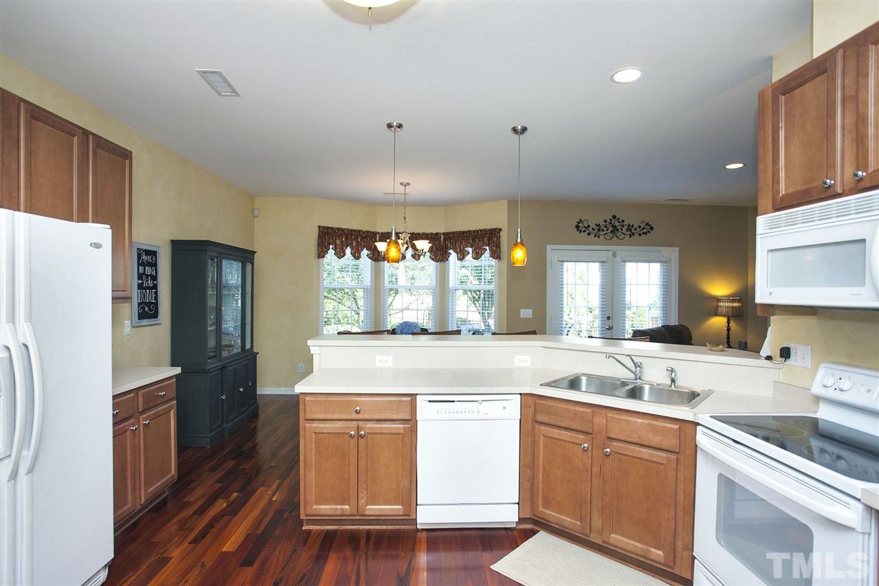 308 Inkster Cove Raleigh, NC 27603 - Photo 9 of 25 a large kitchen with a sink stainless steel appliances and cabinets