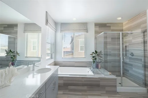 a bathroom with a granite countertop bathtub shower sink and mirror