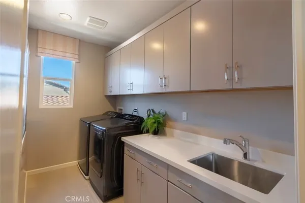 a view of a kitchen with sink and washer