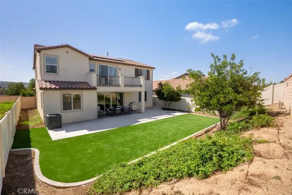 a view of house with backyard outdoor seating and entertaining space