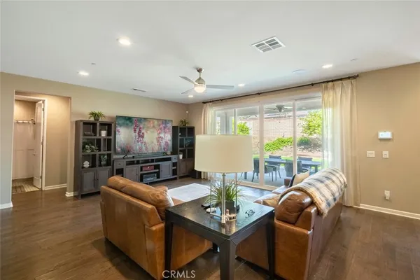a living room with furniture a large window and a flat screen tv