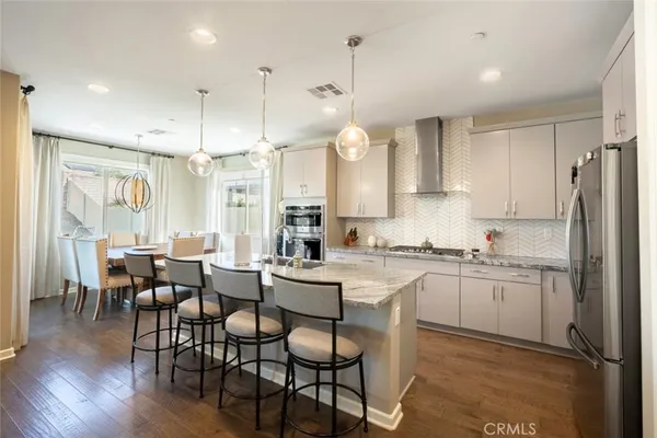 a large kitchen with a table and chairs