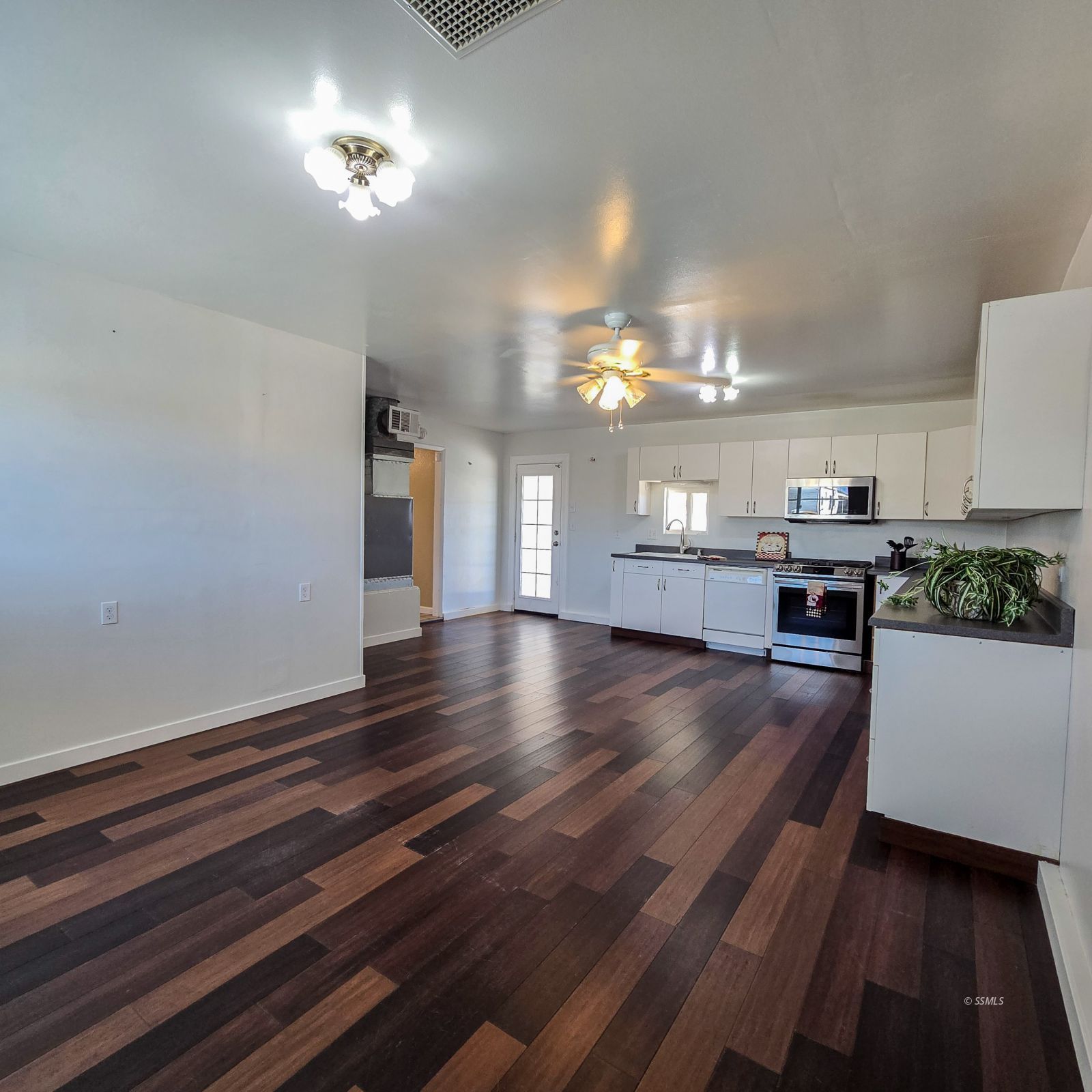 1436 Mayo Street Ridgecrest, CA 93555 - Photo 12 of 29 a view of a room with kitchen island stainless steel appliances wooden floor and stove