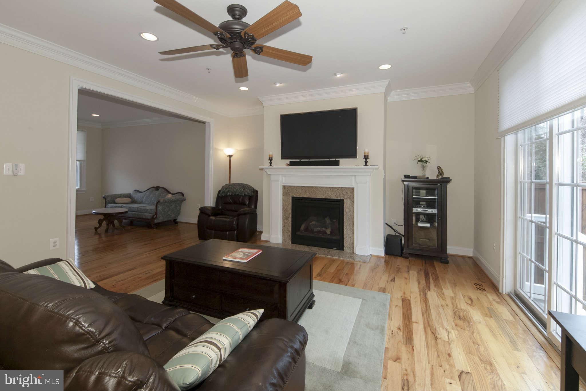 8910 Ridge Place Bethesda, MD 20817 - Photo 8 of 30 a living room with furniture a flat screen tv and a fireplace