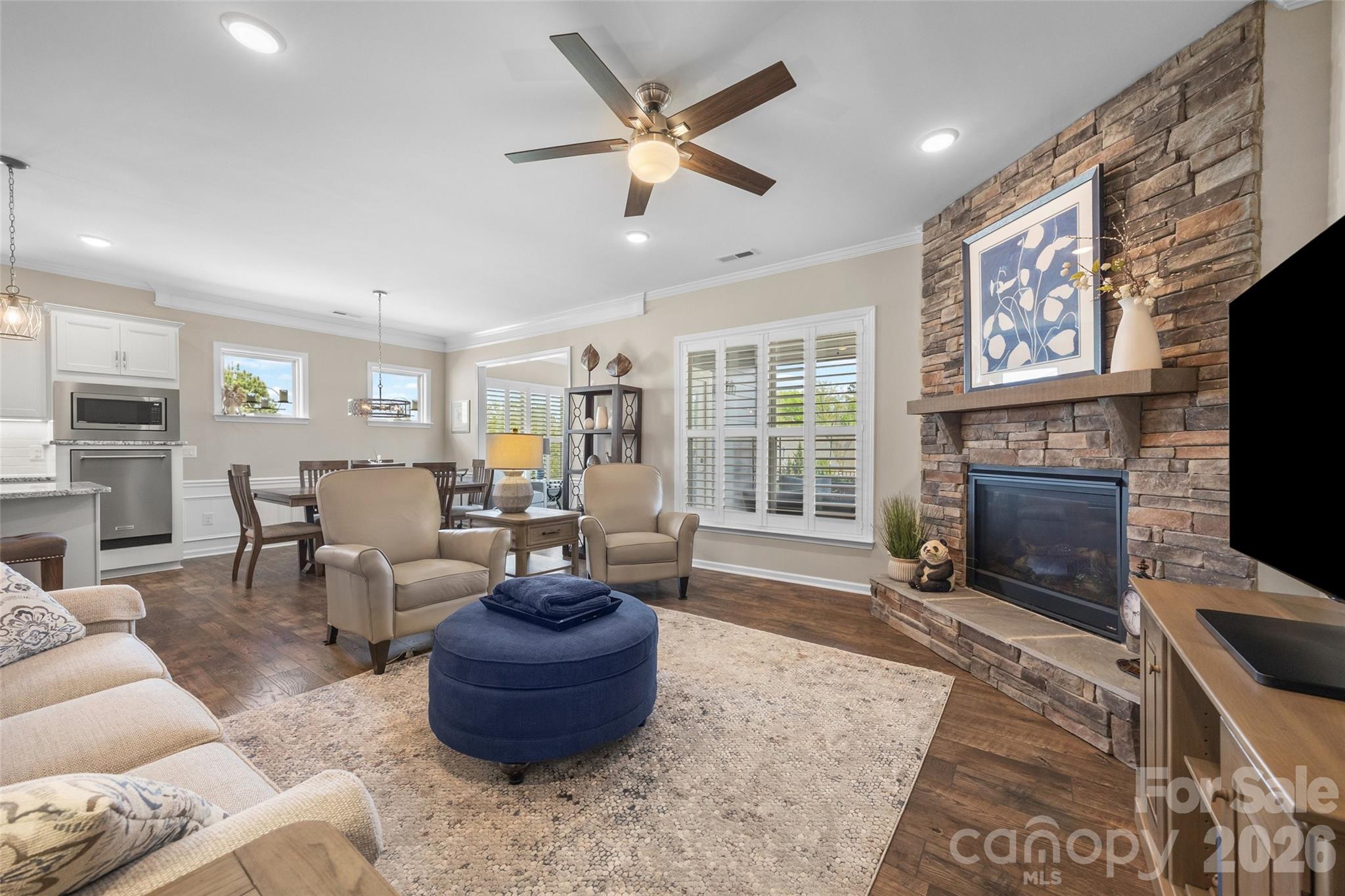 836 Bliss Drive Fort Mill, SC 29715 - Photo 17 of 47 a living room with furniture a fireplace and a flat screen tv