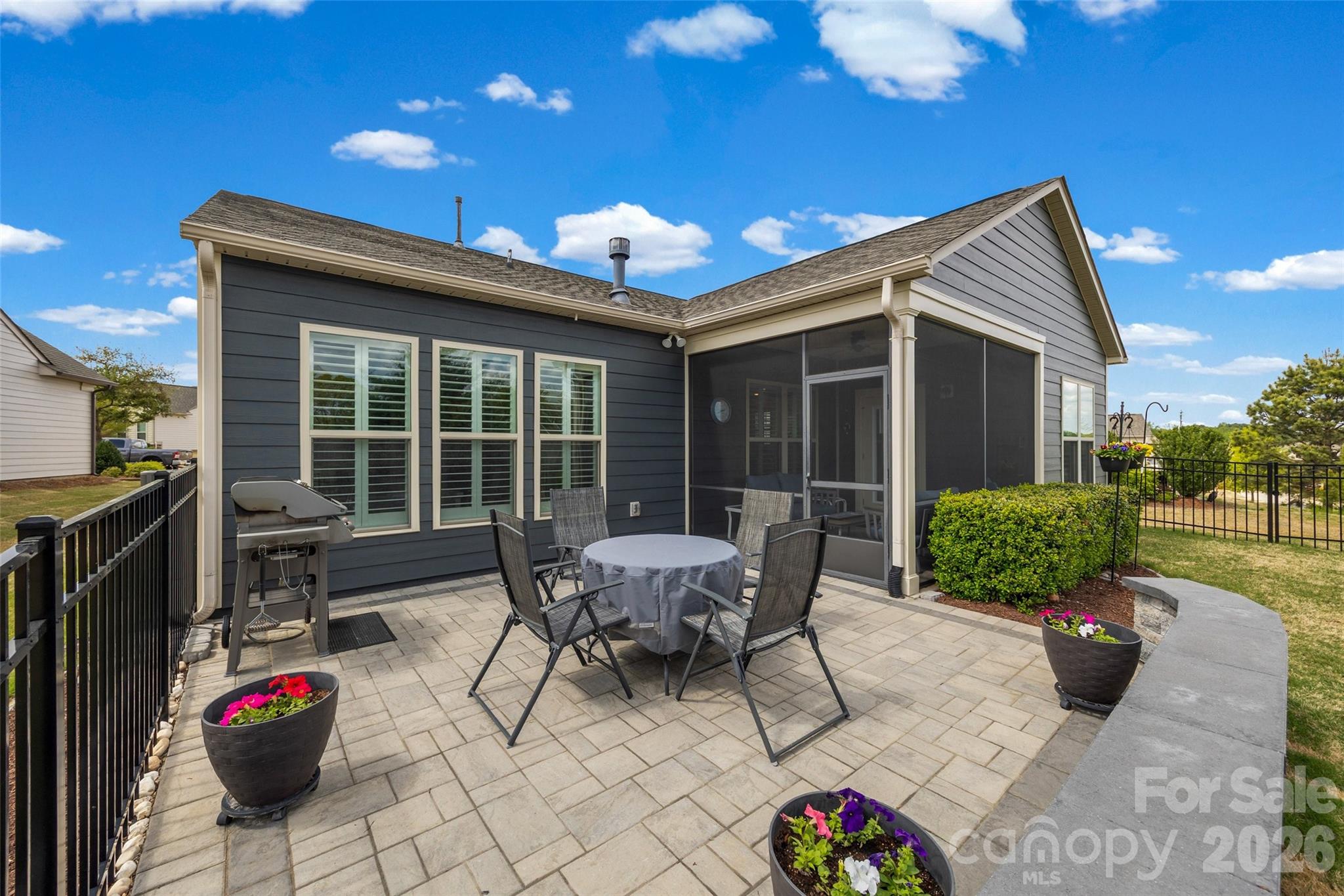 836 Bliss Drive Fort Mill, SC 29715 - Photo 5 of 47 a view of a patio with a table and chairs and potted plants