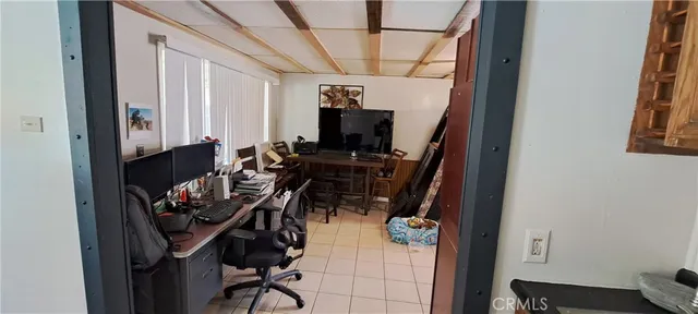 a view of a workspace with furniture and a window