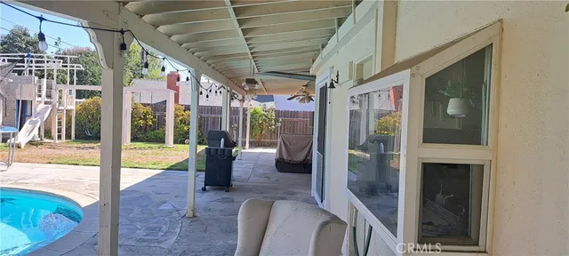 a view of a porch with chairs and backyard