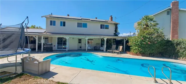 a view of a swimming pool with a patio