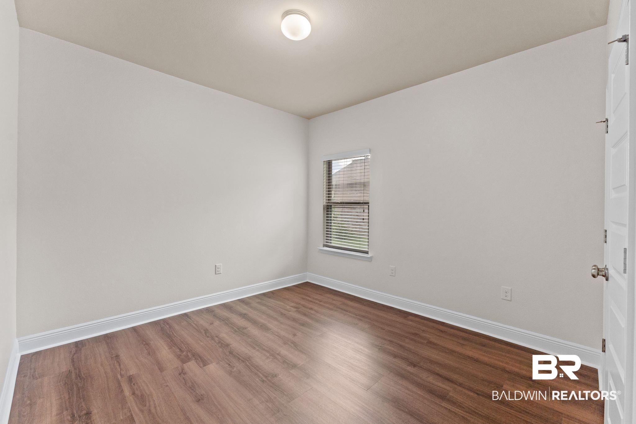 1464 Surrey Loop Foley, AL 36535 - Photo 20 of 24 Empty room featuring wood finished floors