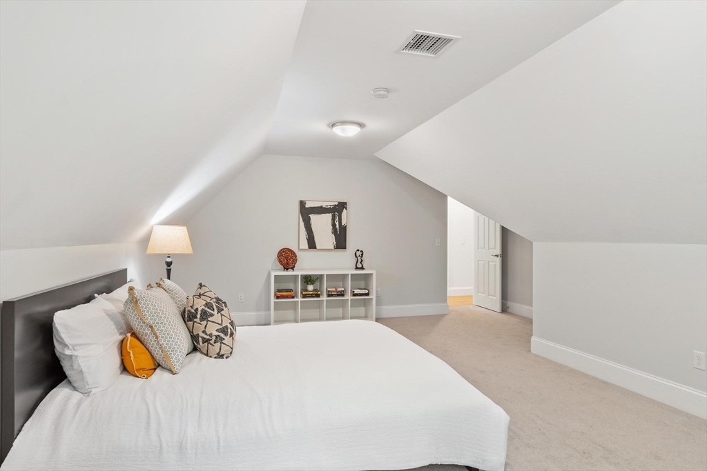 56 Old Marlboro Road Concord, MA 01742 - Photo 19 of 34 a bedroom with a bed and a chandelier
