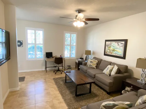 a living room with furniture a chandelier and a window