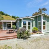 a front view of a house with a garden and patio
