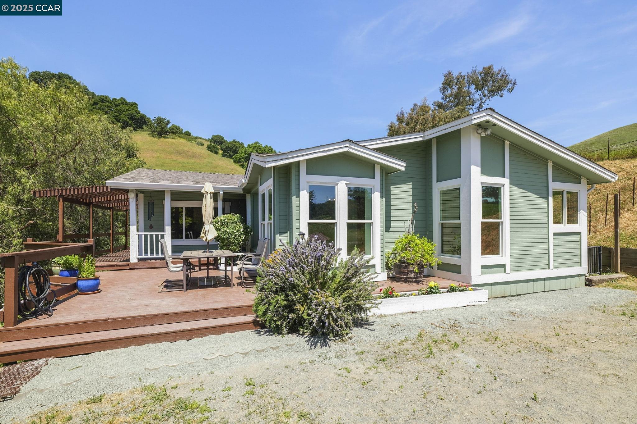 a front view of a house with a garden and patio