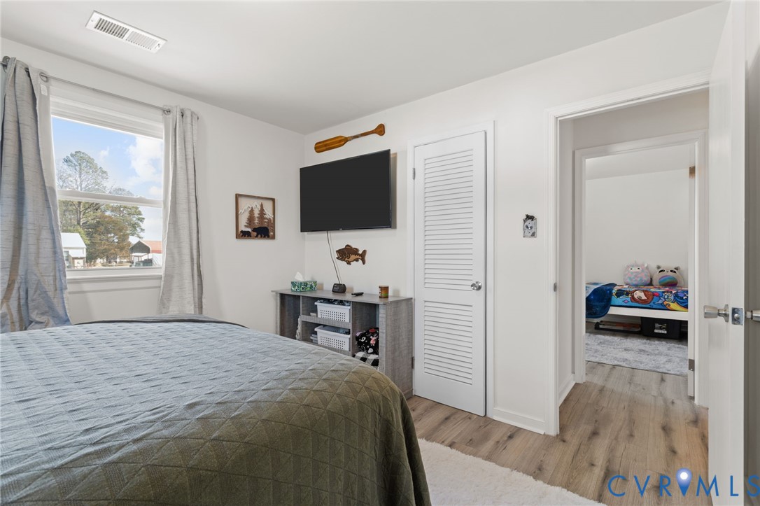 7547 Media Park Road Henrico, VA 23231 - Photo 17 of 24 a bedroom with a bed and a flat screen tv