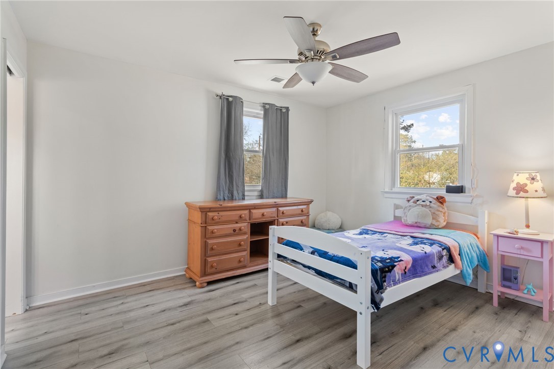 7547 Media Park Road Henrico, VA 23231 - Photo 21 of 24 a bedroom with a bed and a chandelier