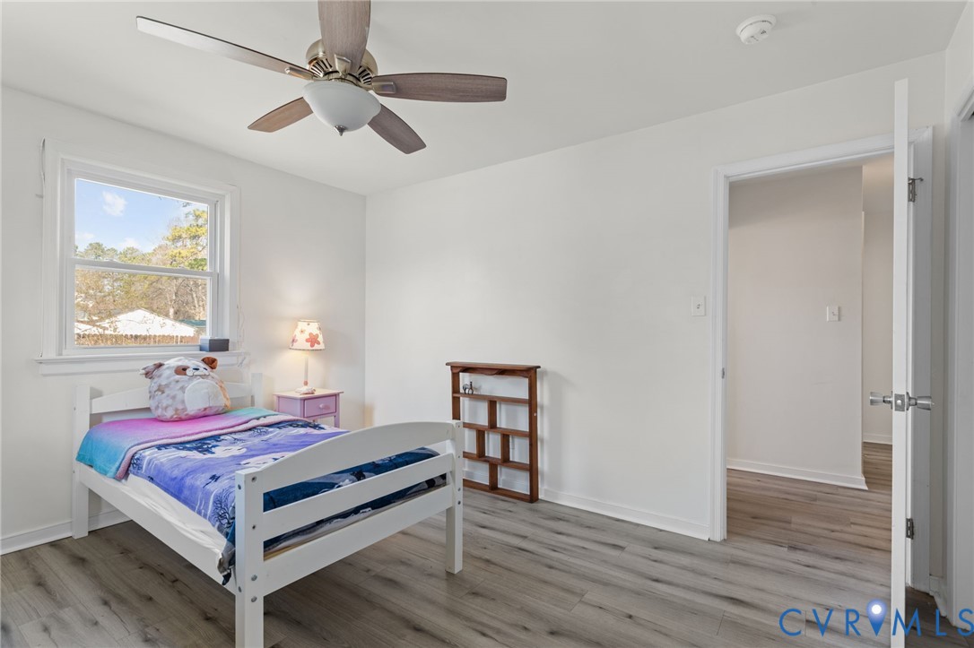 7547 Media Park Road Henrico, VA 23231 - Photo 22 of 24 a bedroom with a bed and a chandelier