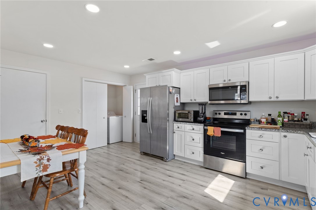 7547 Media Park Road Henrico, VA 23231 - Photo 9 of 24 a kitchen with stainless steel appliances kitchen island granite countertop a refrigerator and microwave