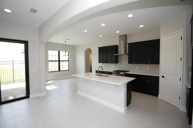 a kitchen with stainless steel appliances a sink stove and cabinets