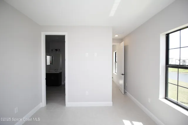 an empty room with windows and closet