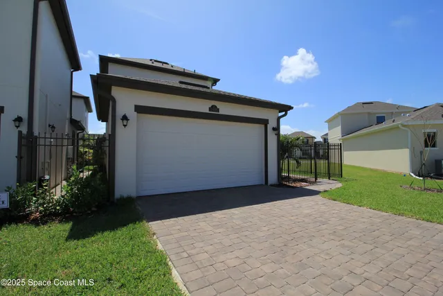 a view of a house with a yard and a garage