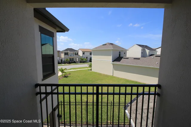a view of a balcony with a yard