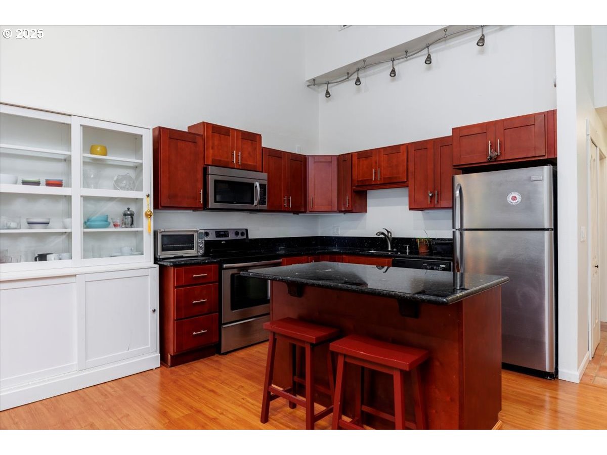 100 Kerr Parkway, Unit 34 Lake Oswego, OR 97035 - Photo 11 of 35 a kitchen with stainless steel appliances a stove refrigerator sink and cabinets