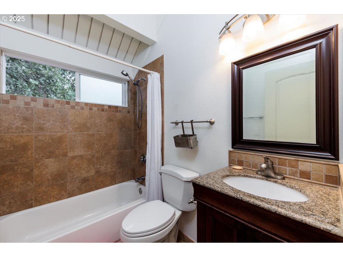 100 Kerr Parkway, Unit 34 Lake Oswego, OR 97035 - Photo 21 of 35 a bathroom with a granite countertop sink toilet a mirror and shower