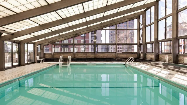 a view of a swimming pool with outdoor seating