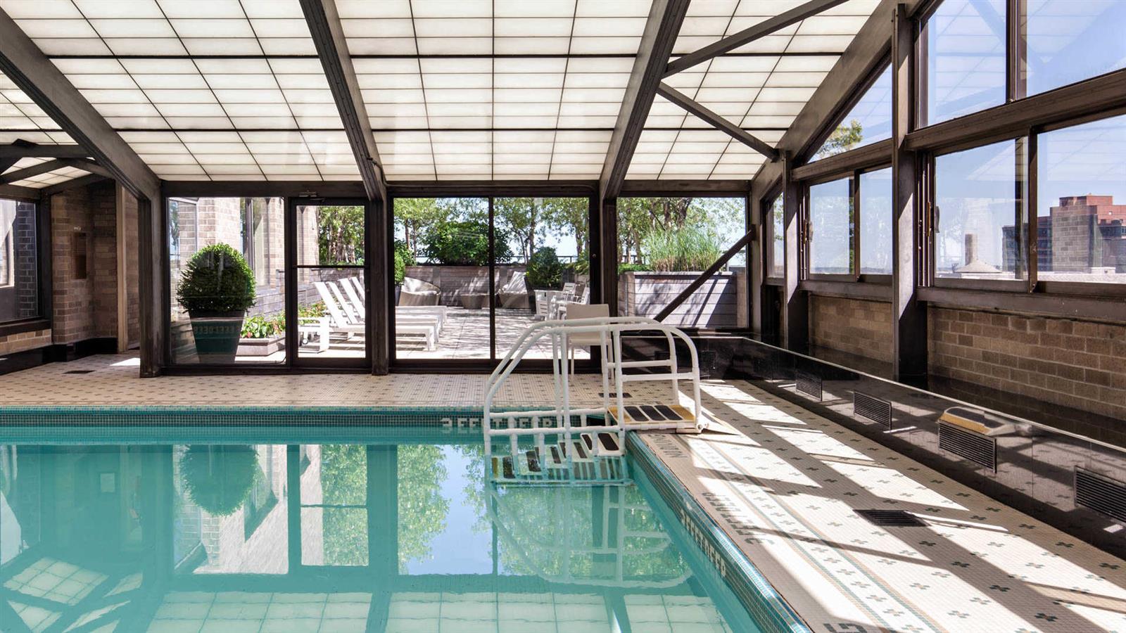 245 East 40th Street, Unit 24J Manhattan, NY 10016 - Photo 9 of 10 a view of a swimming pool with outdoor seating