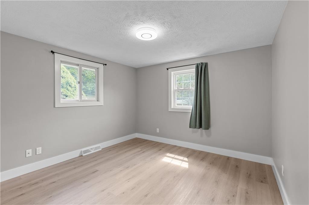 309 Vaneal Road Washington, PA 15301 - Photo 18 of 30 a view of empty room with wooden floor and fan