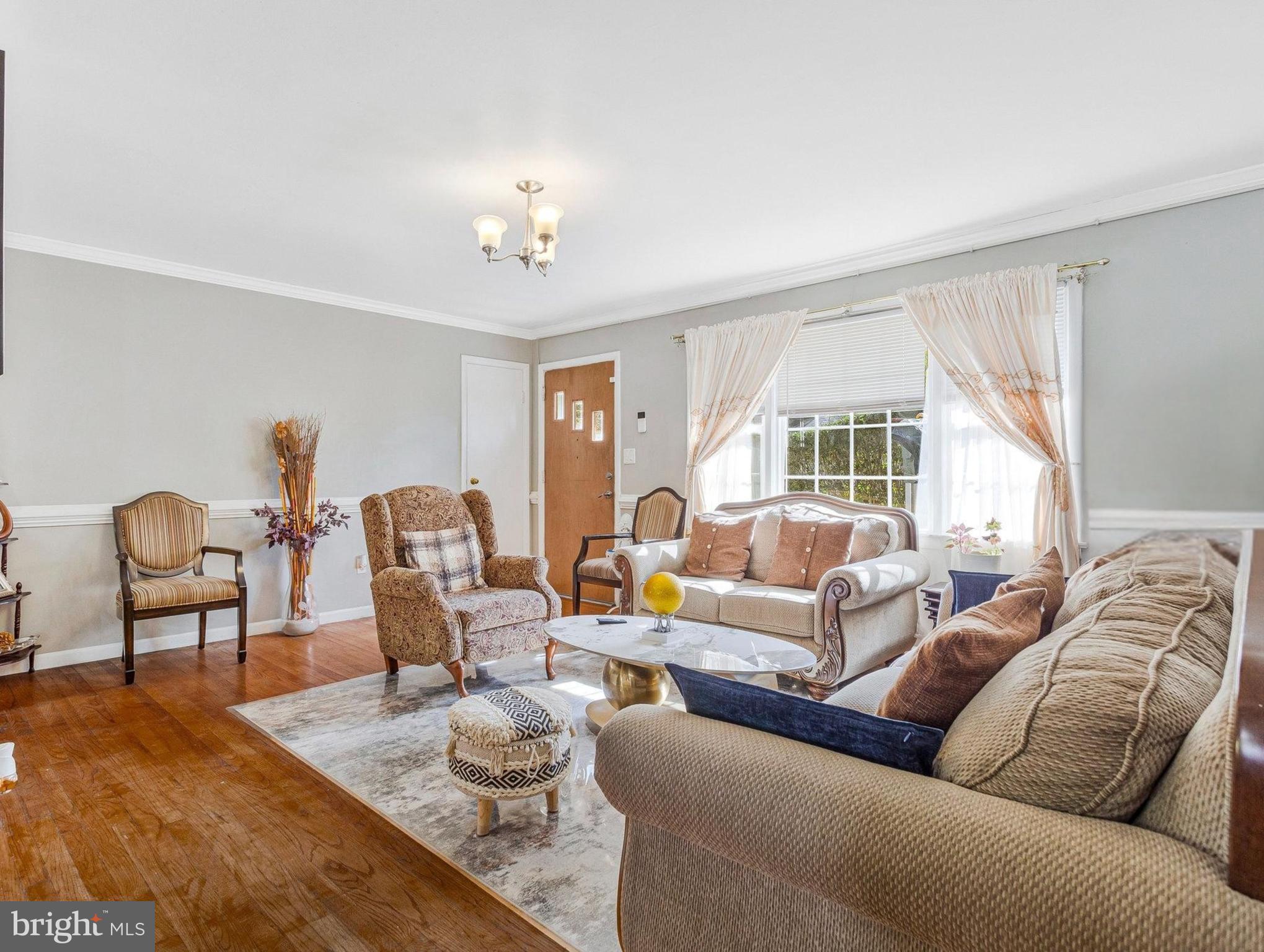 7314 Powhatan Street Lanham, MD 20706 - Photo 3 of 19 a living room with furniture potted plant and a large window