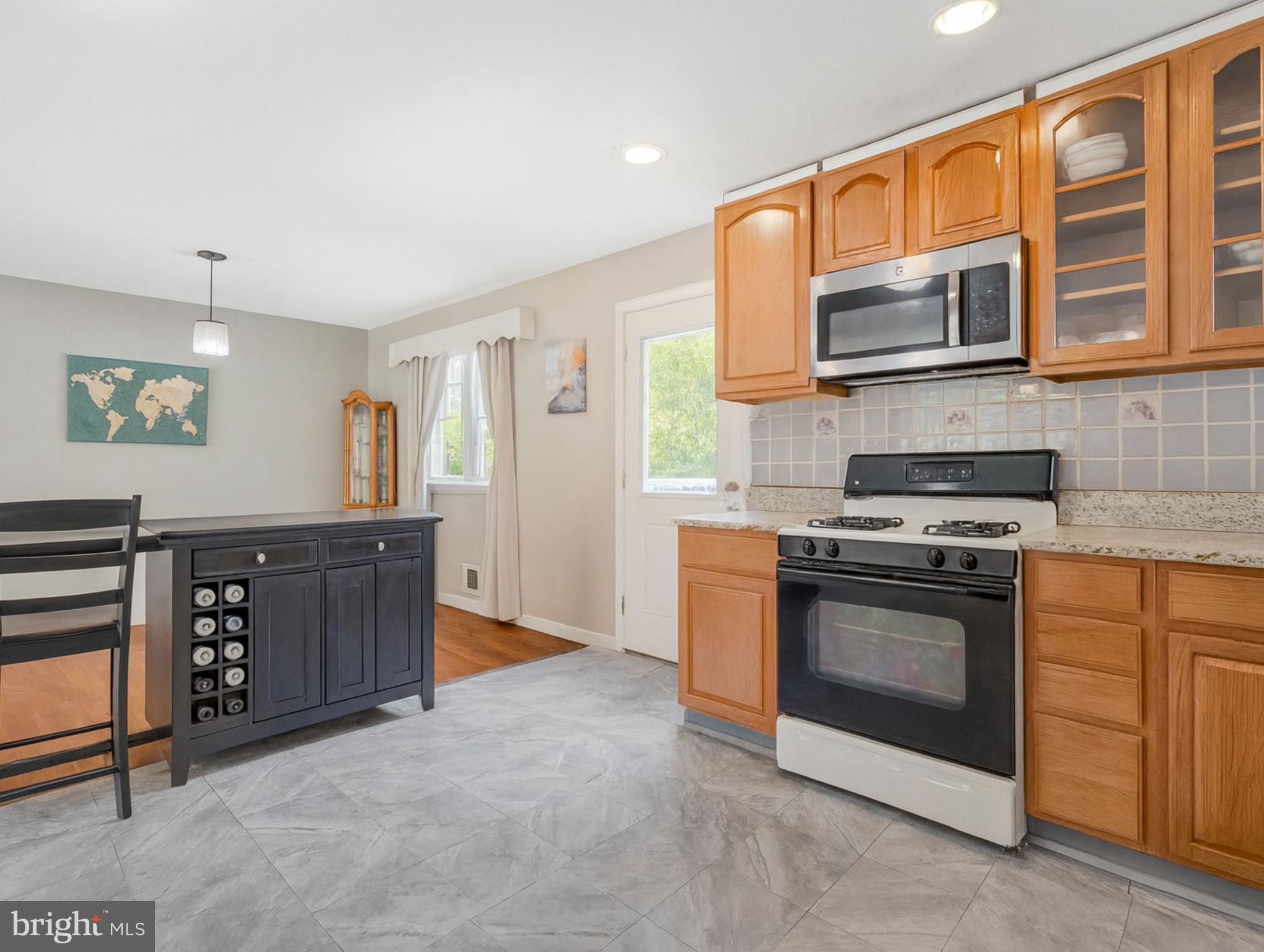 7314 Powhatan Street Lanham, MD 20706 - Photo 9 of 19 a kitchen with stainless steel appliances granite countertop a stove and a microwave