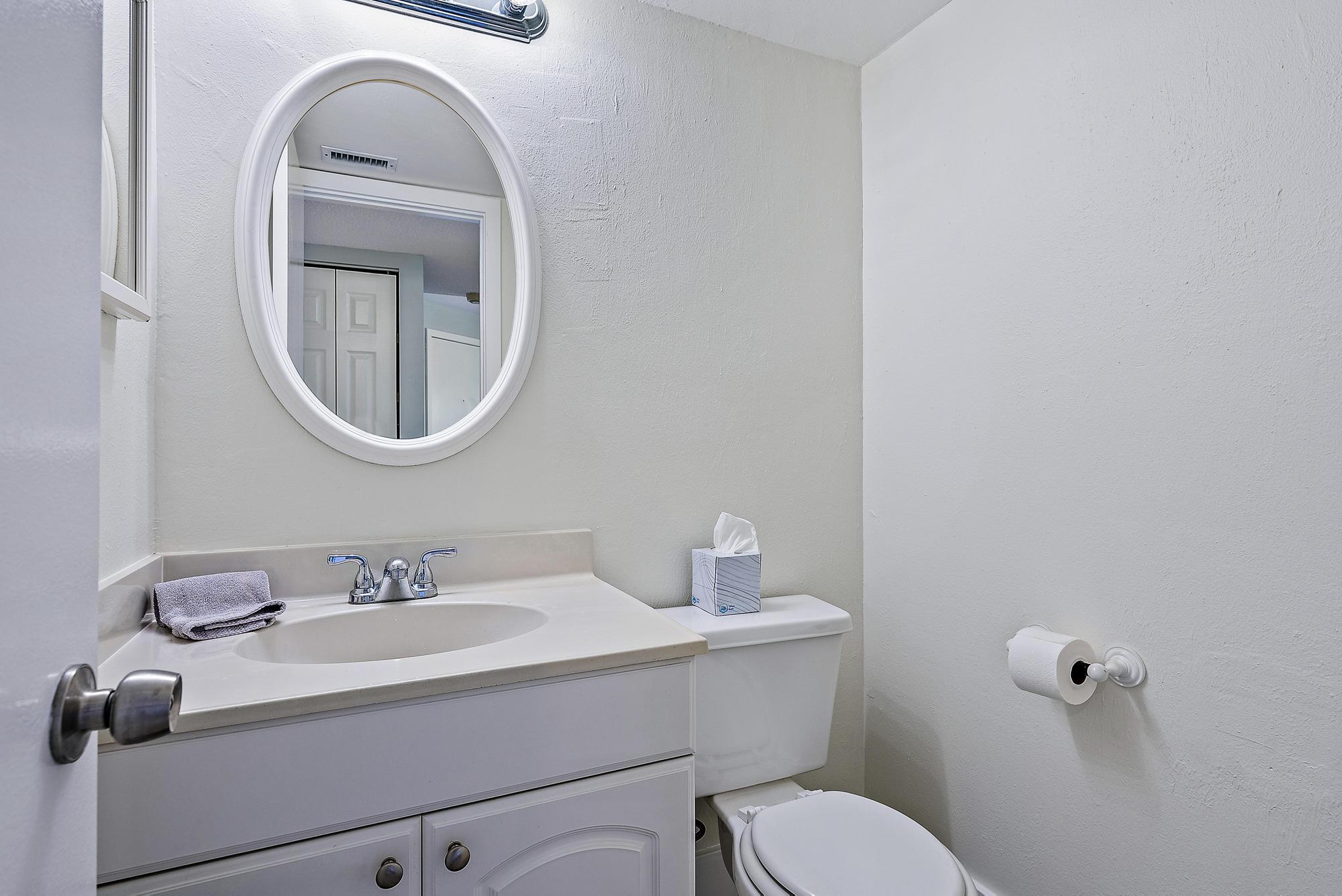 1605 Highway 1, Unit V2204 Jupiter, FL 33477 - Photo 17 of 31 a bathroom with a toilet sink and mirror