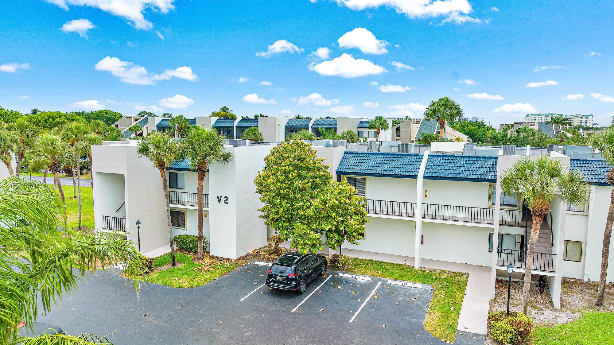 1605 Highway 1, Unit V2204 Jupiter, FL 33477 - Photo 20 of 31 a view of a swimming pool with a patio and a garden