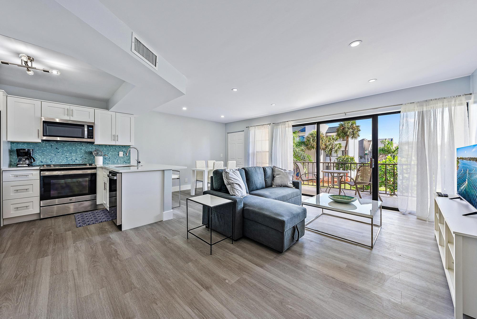 1605 Highway 1, Unit V2204 Jupiter, FL 33477 - Photo 5 of 31 a living room with furniture and a flat screen tv