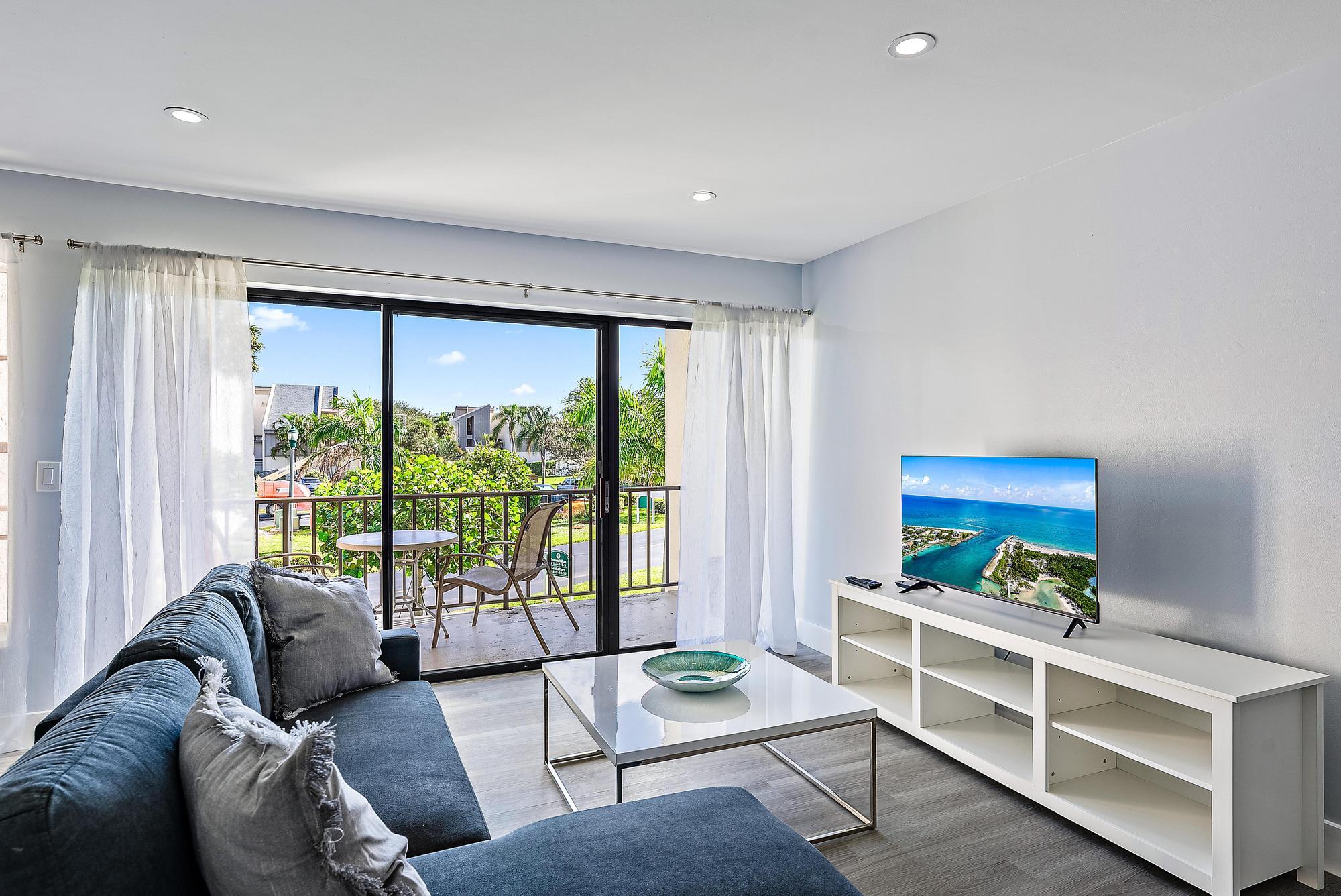 1605 Highway 1, Unit V2204 Jupiter, FL 33477 - Photo 6 of 31 a living room with furniture and a window