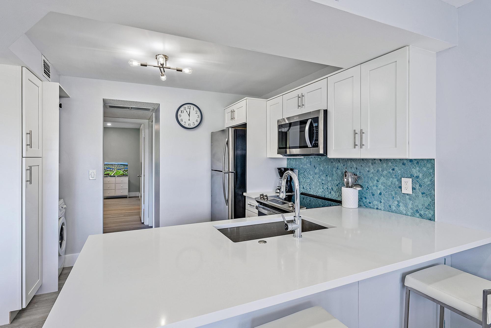 1605 Highway 1, Unit V2204 Jupiter, FL 33477 - Photo 7 of 31 a bedroom with a bed and a television