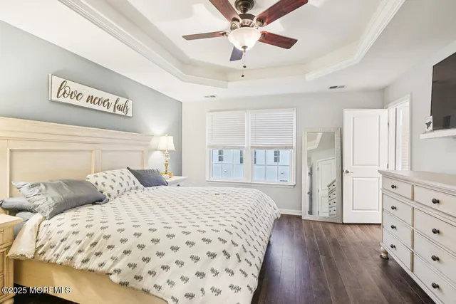 a bedroom with a large bed and a chandelier