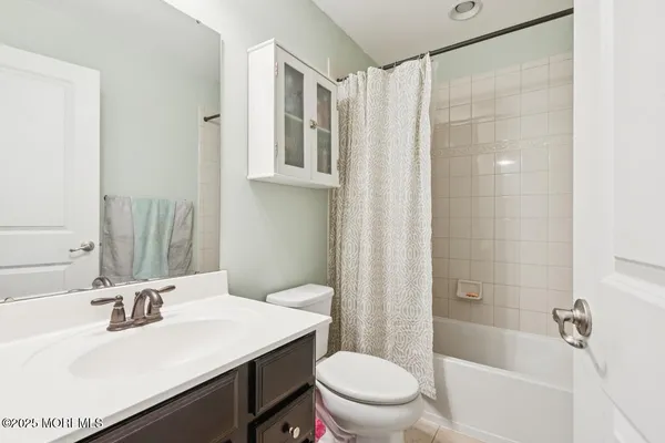 a bathroom with a sink toilet a mirror and shower