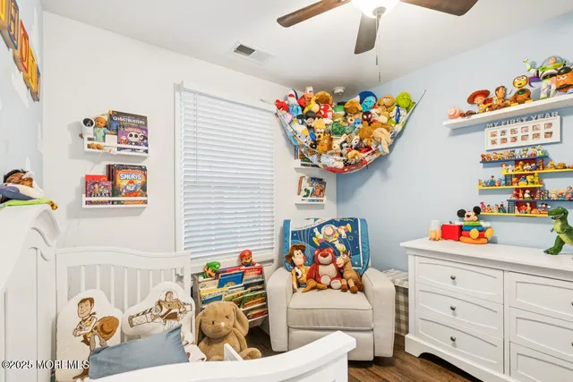 a bedroom with a bed and a dresser in it