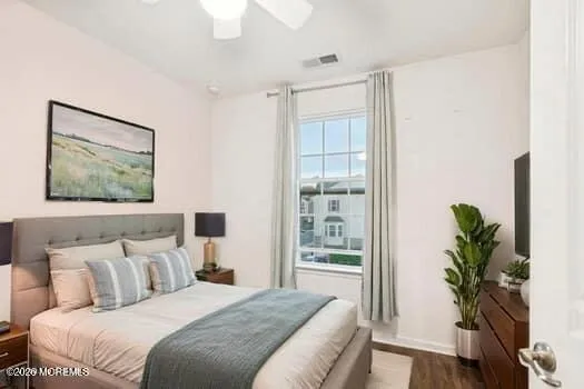 a bedroom with a large bed and a potted plant