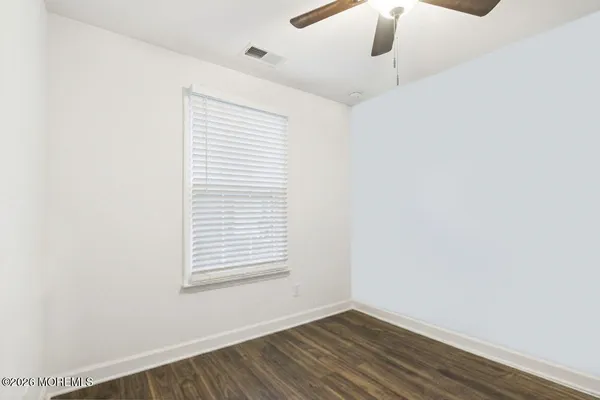 a view of wooden floor and windows in a room