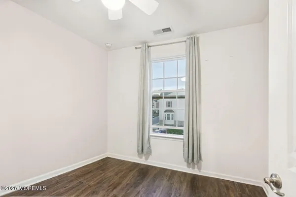 a view of wooden floor and windows in a room