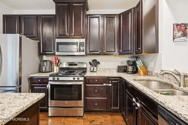 a kitchen with a sink stove and refrigerator