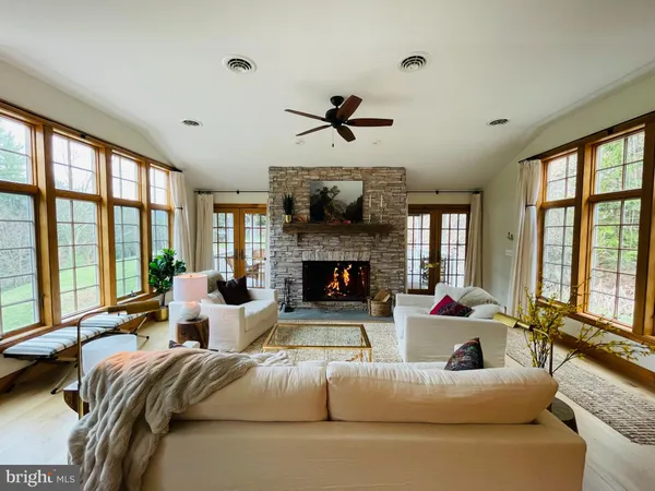 a living room with furniture and a fireplace